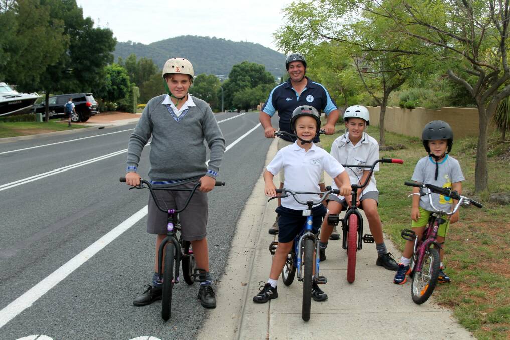 Jamie Cregan with his sons Lachlan, 13, Thomas, 6, Joshua, 11, and Lucas, 4 enjoying a bike ride in Jerrabomberra. Photo: Kimberley Le Lievre.