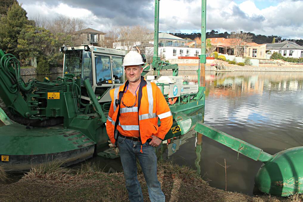 Dredging Systems owner-operator Anto Pratten stands in front of the amphibious dredge currently removing excess sediment from Lake Jerrabomberra. Photo: Gemma Varcoe. 