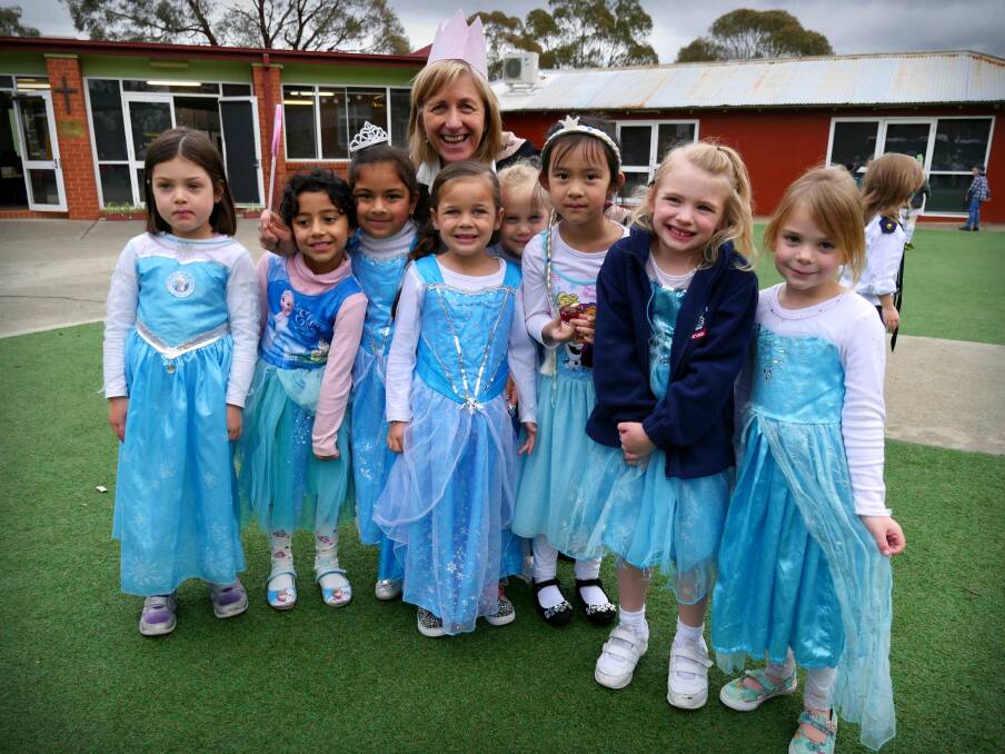 Caroline Tanti stands with eight kindergarten students who all say they want to be Elsa from Frozen when they grow up. Photo: Amanda Copp.