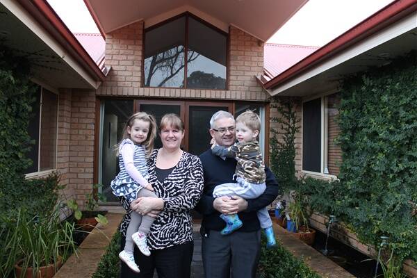 Jerrabomberra residents Kim and Anthony Howatson with twins James and Riley. The Howatsons say that although they take home a good pay packet, it's largely eaten up by their mortgage and the cost of childcare.