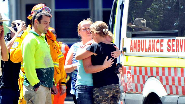 People react on the scene as a child is taken away by ambulance. Photo: Kylie Pitt