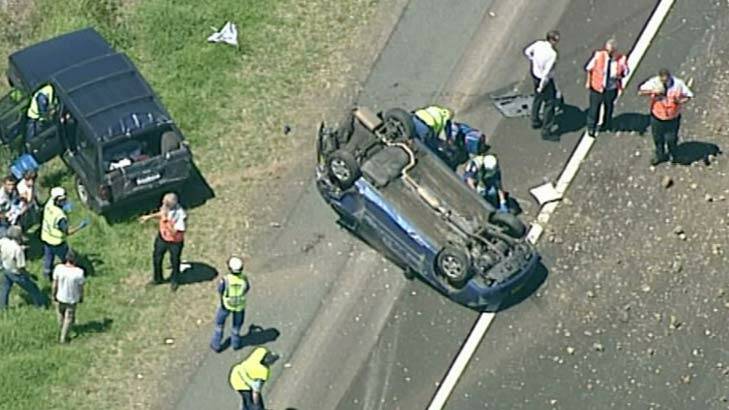 An overturned car on the Hume Highway near the Narellan Interchange. Photo: Channel Nine