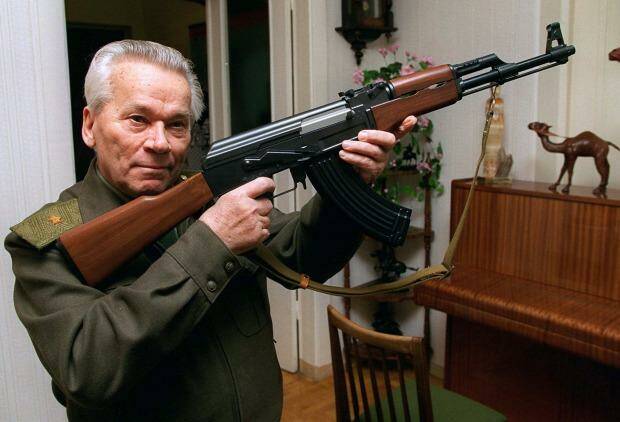 Gun creator ... Mikhail Kalashnikov shows a model of his world-famous AK-47 assault rifle at home in the Ural Mountain city of Izhevsk in 1997.
