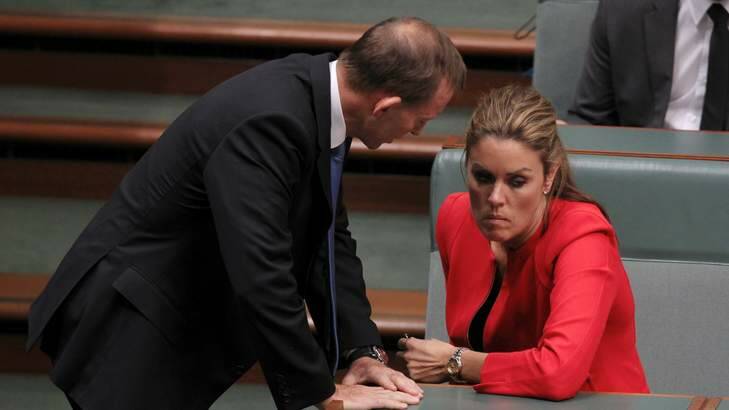 Mutual loyalty: Prime Minister Tony Abbott, then opposition leader, speaks to his chief of staff Peta Credlin in Parliament. Photo: Alex Ellinghausen