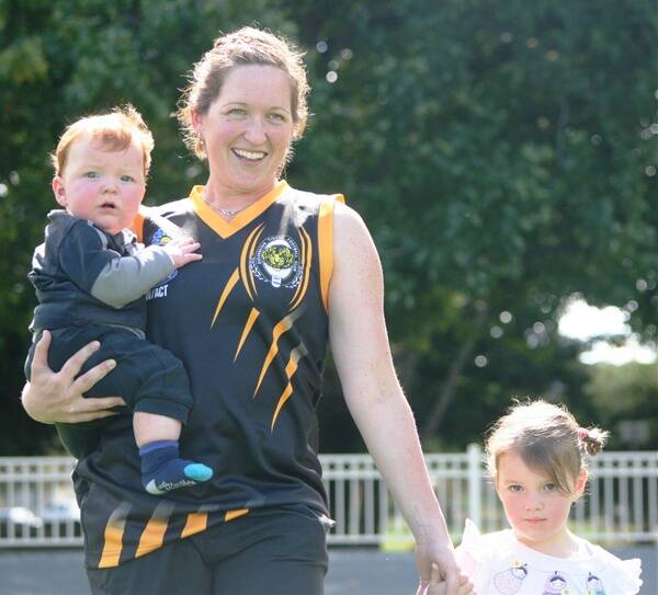 Jacinta Froud, with son Blake and daughter Eve, is one of a number of Tigerettes players returning from motherhood duties this season. Photo: Andrew Johnston 