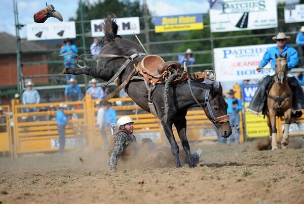 Bruce Curry gets knocked out of his boots during the novice saddle bronc event. Photo: Elesa Lee
