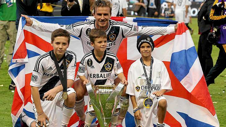 David Beckham of Los Angeles Galaxy poses with his sons Brooklyn, Cruz and Romeo after MLS Cup win.