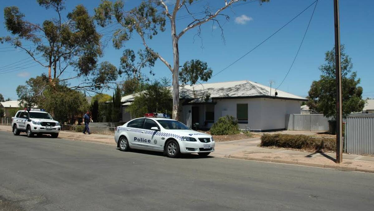 A forensic officer outside a house in Port Pirie where a man, accused of a tomahawk attack in Laura, lives