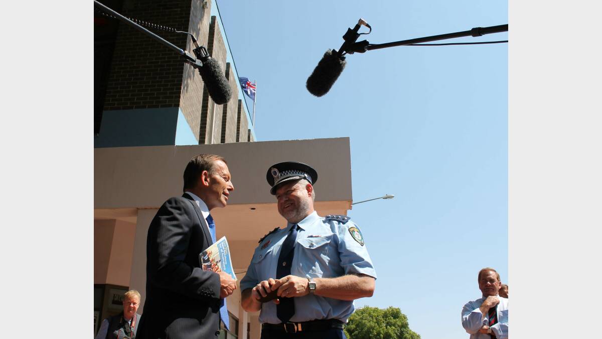 Tony Abbott chats with Queanbeyan police officer Shane Box. Mr Abbott was in Queanbeyan to discuss the Coalition's crime prevention policies. Photo: Andrew Johnston