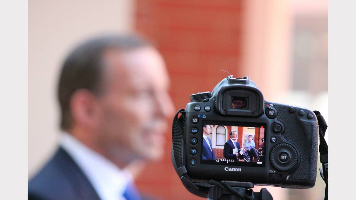 Tony Abbott is recorded on video during his remarks to the media. Photo: Andrew Johnston