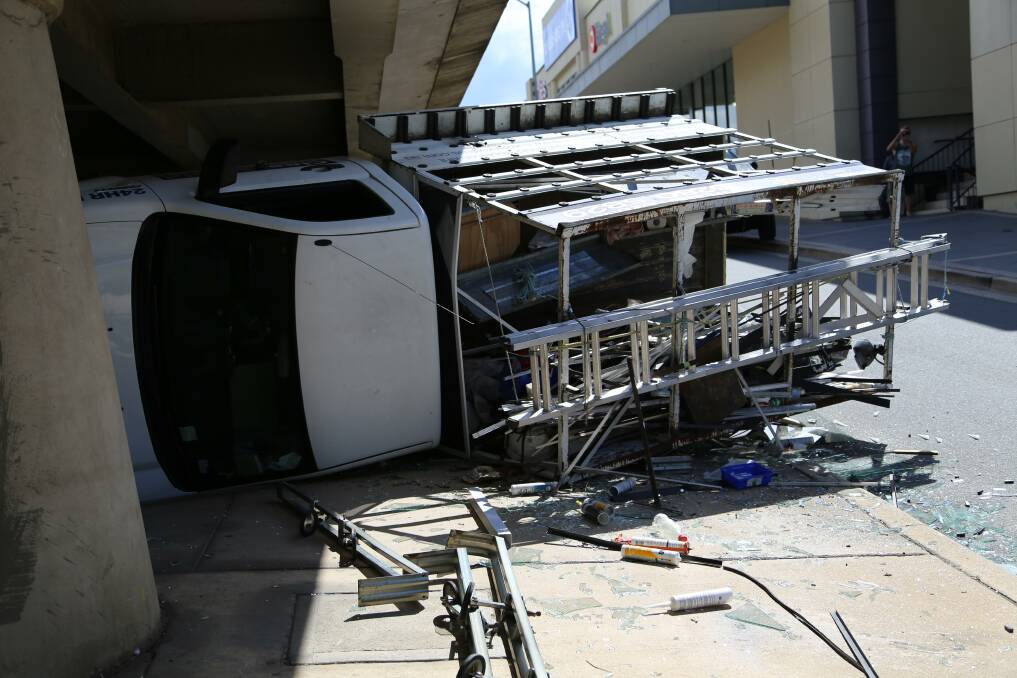 A 38-YEAR-OLD Queanbeyan man could face negligent driving charges after his truck clipped the underside of Queens Bridge and rolled on Monday afternoon. Photo: Kim Pham