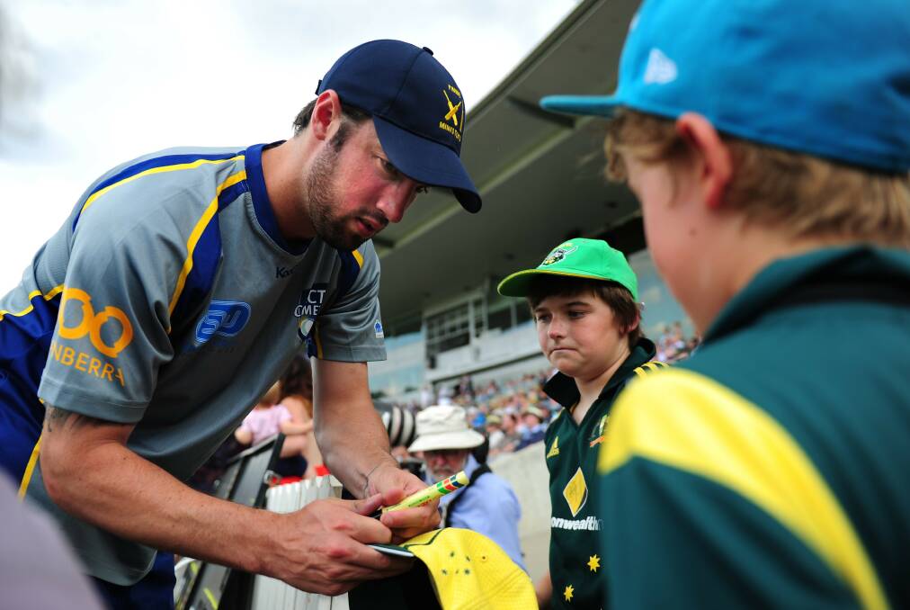 Queanbeyan's Jono Dean signs some autographs during the Prime Minister's XI game earlier this year. Photo: Canberra Times