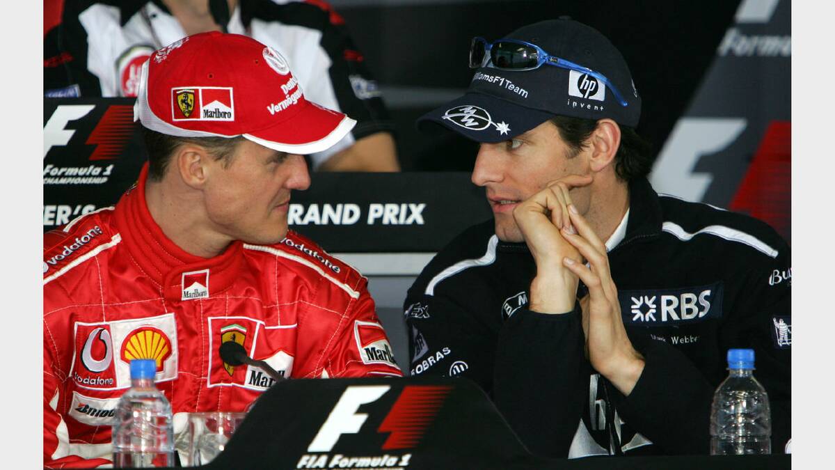 Mark Webber and seven-time World Champion Michael Schumacher converse during the driver's press conference at the 2005 Australian Grand Prix. Photos: Fairfax Media