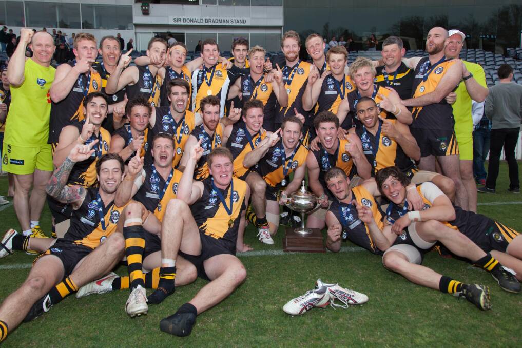 The Queanbeyan Tigers celebrate after their NEAFL Eastern Conference grand final win over the Sydney Swans at Manuka Oval last weekend. Photo: Ben Southall Photography