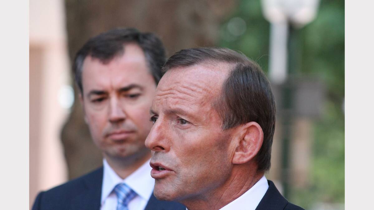 Tony Abbott speaks while shadow Justice minister Michael Keenan looks on. Photo: Andrew Johnston