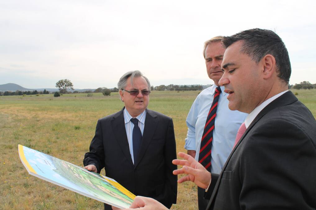 Village Building Company managing director Bob Winnell, Queanbeyan Mayor Tim Overall and Member for Monaro John Barilaro discuss plans for the South Tralee development. Photo: Andrew Johnston