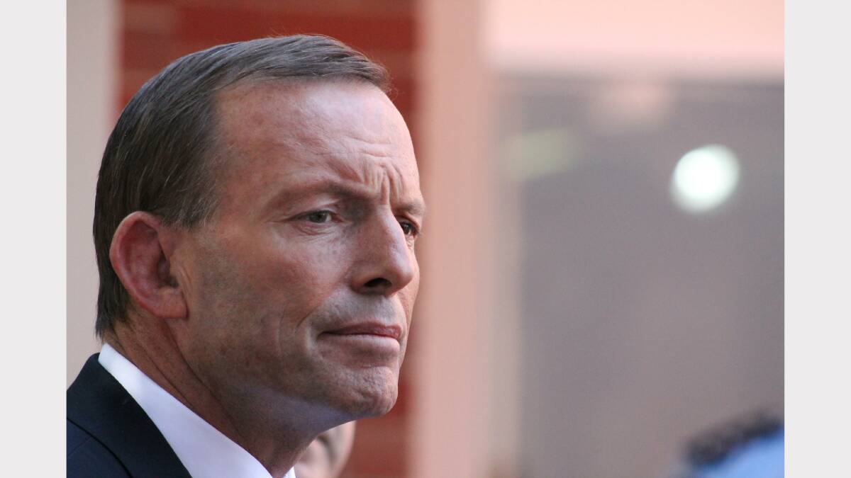 Tony Abbott listens to a reporter's question. Photo: Andrew Johnston