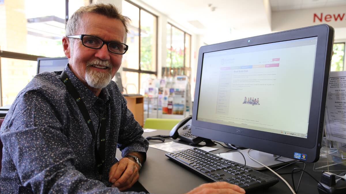Queanbeyan City Library manager Peter Conlon navigates his way around the library's new website. Photo: Kim Pham.