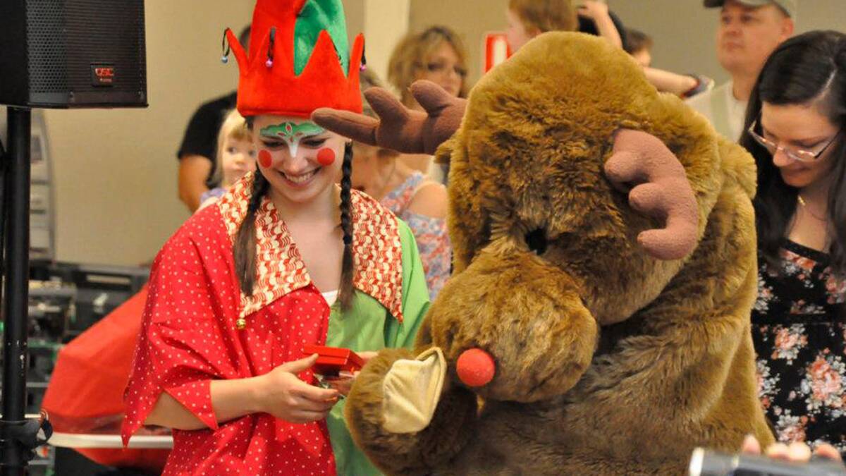 Rudolph and one of Santa's Christmas elves prepare for his arrival this Saturday at Riverside Plaza.