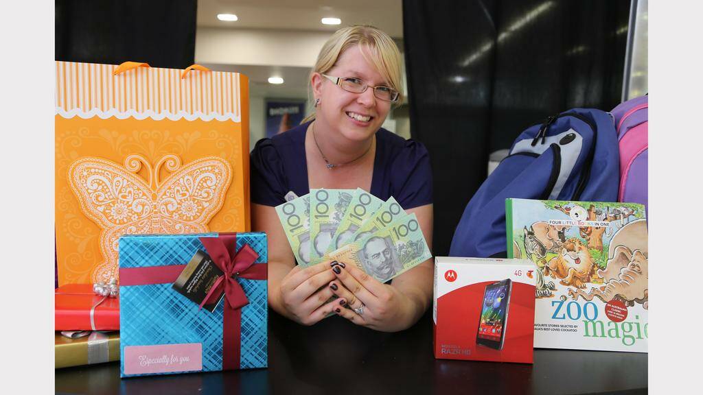Riverside Plaza marketing manager Heidi Flaherty with some of the prizes customers can claim in the Frequent Buyers promotion.