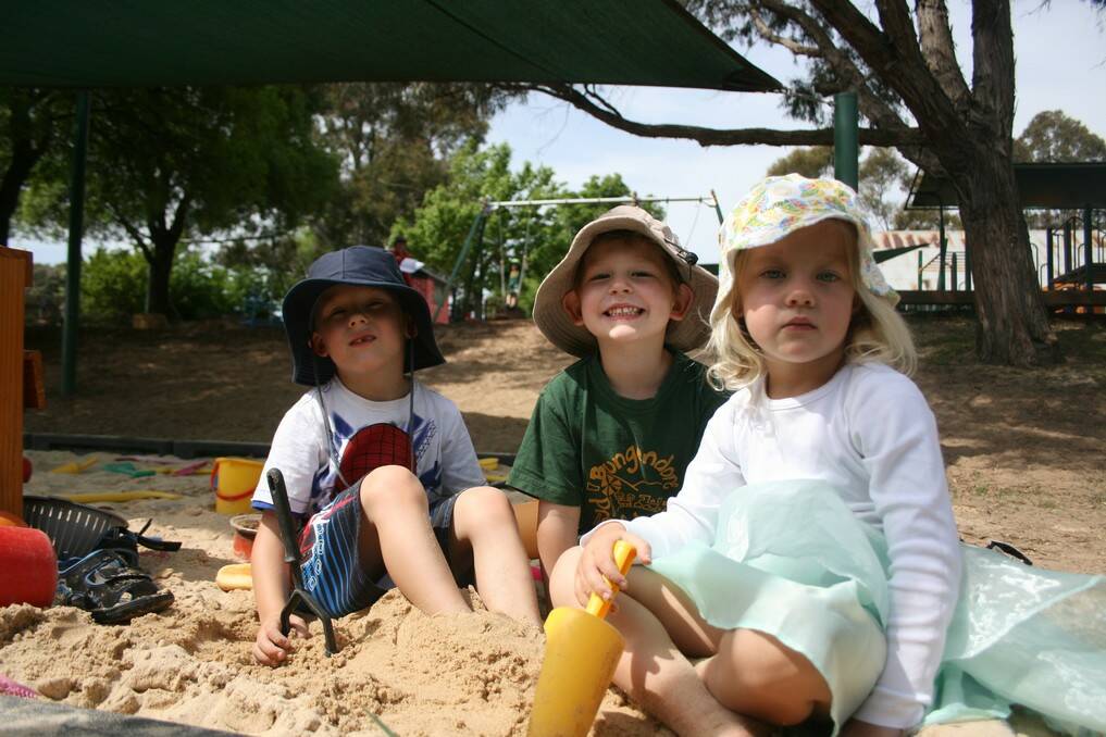 Cooper, Frankie and Mia have a dig in the playground's sand pit