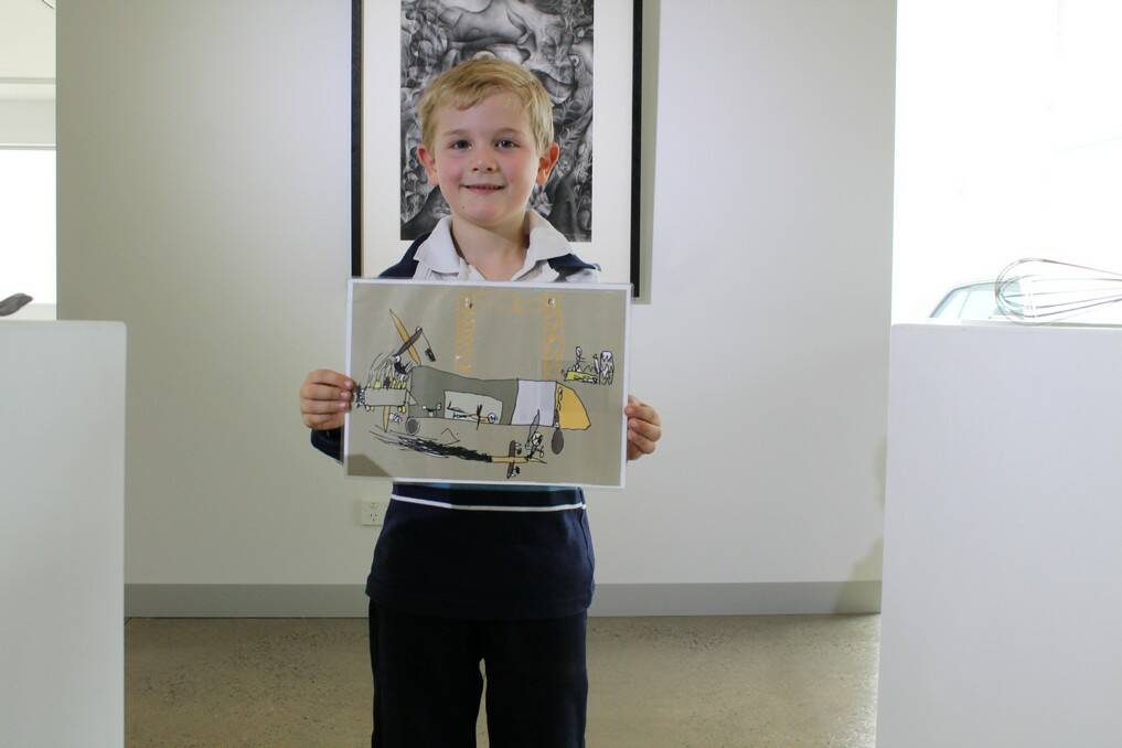 Angus Primrose, 6, has won a Young Australia Art Award for his computer illustration "Aircraft Hangar". Photo: Kim Pham.