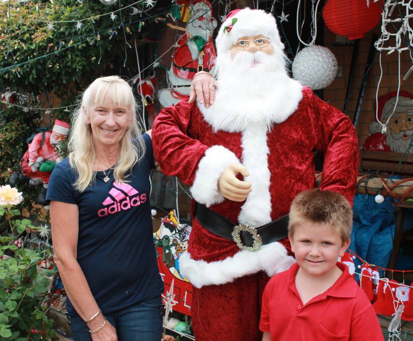 Queanbeyan's Anita Taylor, pictured with her grandson Brock, began putting up Christmas decorations on her Meehan Close home since October.