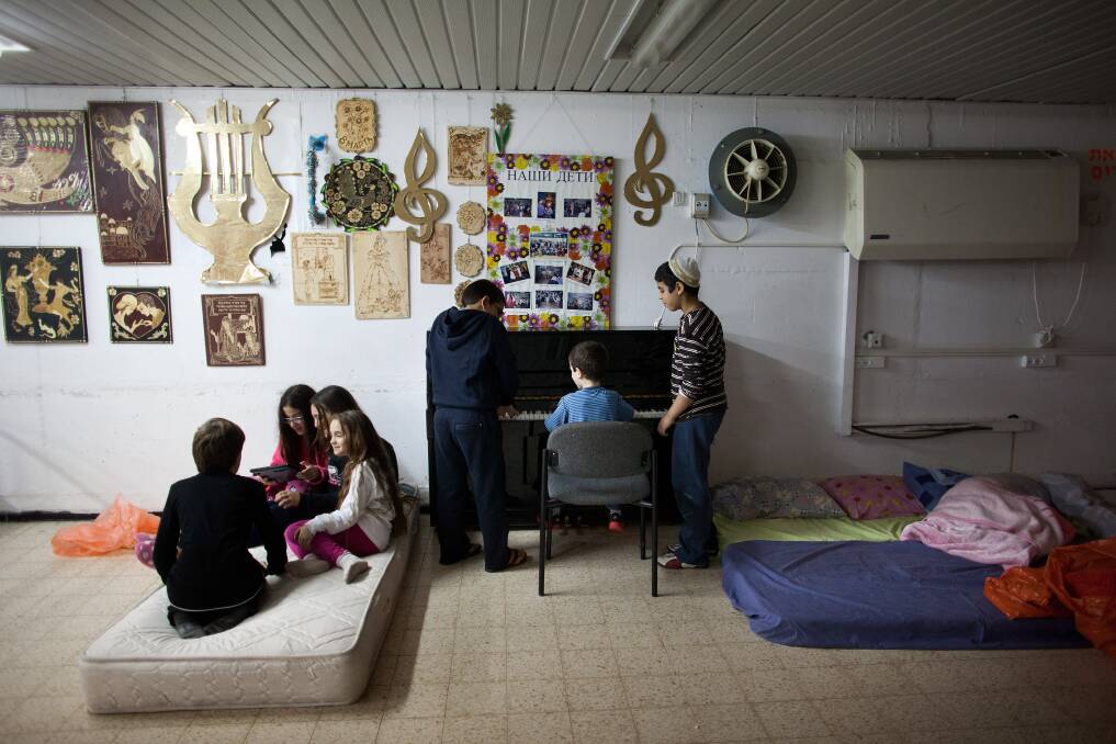 Israeli children play games at a bomb shelter in Netivot, Israel. Photo by Uriel Sinai/Getty Images