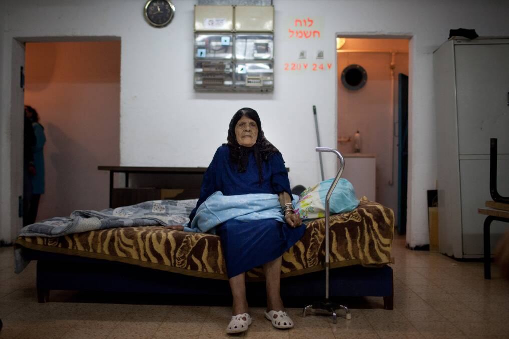 An Israeli woman sits inside a bomb shelter on November 14, 2012 in Netivot, Israel. Photo by Uriel Sinai/Getty Images