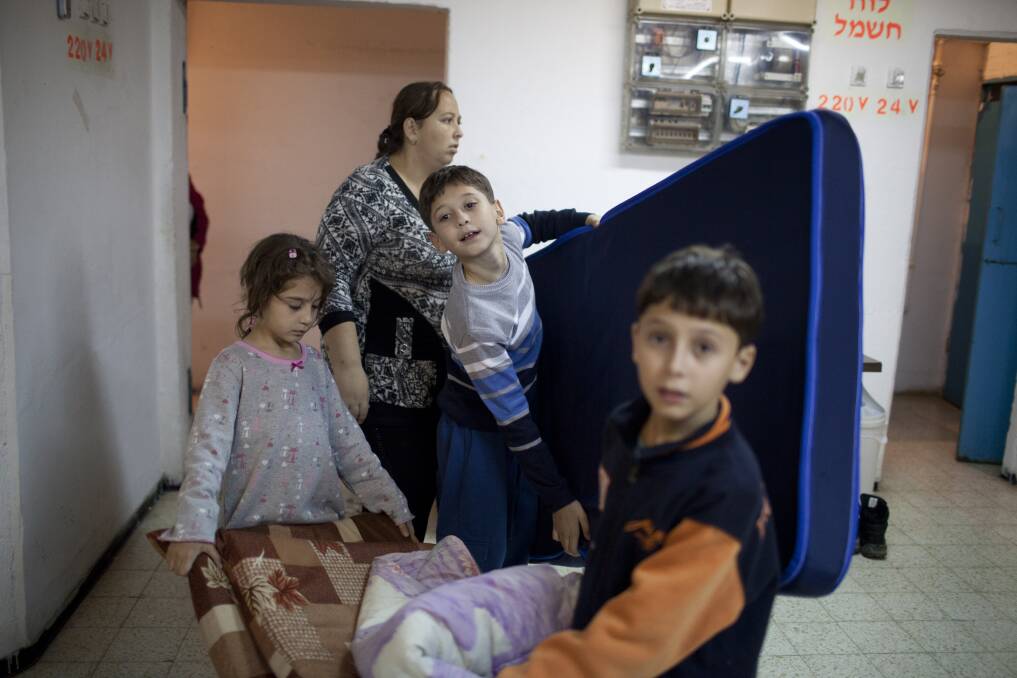 Israeli children sit in a bomb shelter on November 14, 2012 in Netivot, Israel. Photo by Uriel Sinai/Getty Images