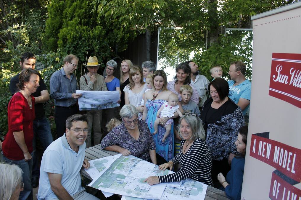 Stina Kerans (front right) reviews plans of the new Sun Villages with supporters and potential investors at the site of the proposed multi-unit development.