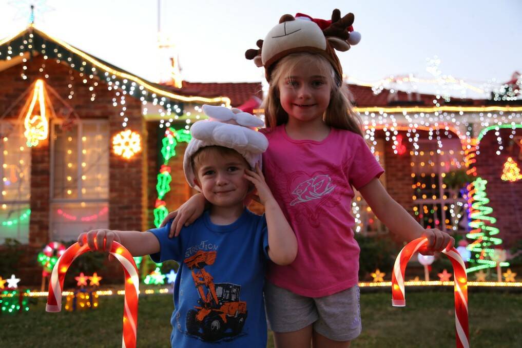Luke, 3 and Chloe Amey, 6 among the Christmas lights display at their home at 12 Wangara Crescent, Queanbeyan.