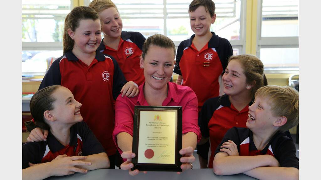 Queanbeyan East Public School teacher Kristen Campbell recently received the Member for Monaro Excellence in Education Award. Year five students Shakira Busic, Chloe Gruber, Adam Wood, Declan Perry, Chael Mellor and James Kirland help her celebrate. Photo: Kim Pham.