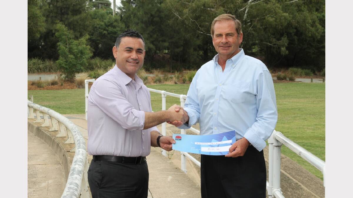 Local member John Barilaro presents Queanbeyan mayor Tim Overall with a cheque for $104,000, the last of the 2010 restoration funding.