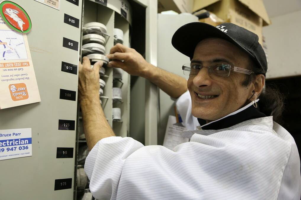 Optical technician Spiro Ahadizad manufactures more than 100 pairs of lenses each week at the onsite laboratory at ACT Optical, Queanbeyan. Photo: Kim Pham.