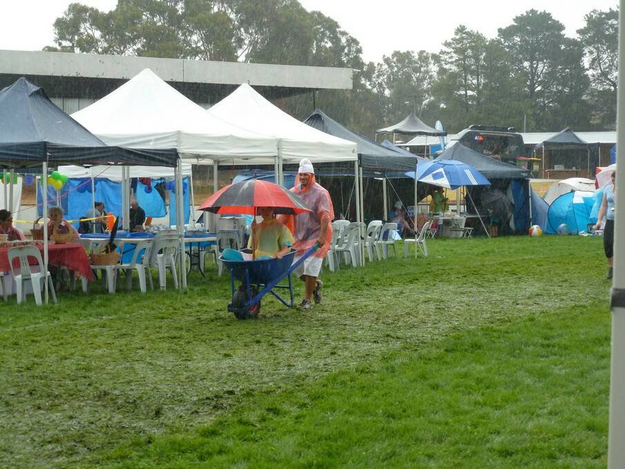 Participants try to keep dry during the 2014 Relay for Life. Photo: supplied.