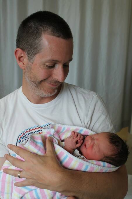 Adrian Davies cradles his first born daughter Claire Ruth Davies born on April 4.