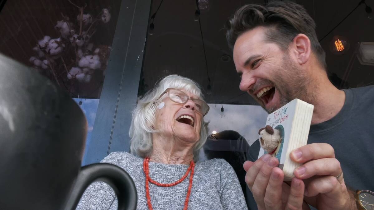 FUN TIMES: Oma shares a giggle with Jason over a puppet book.
