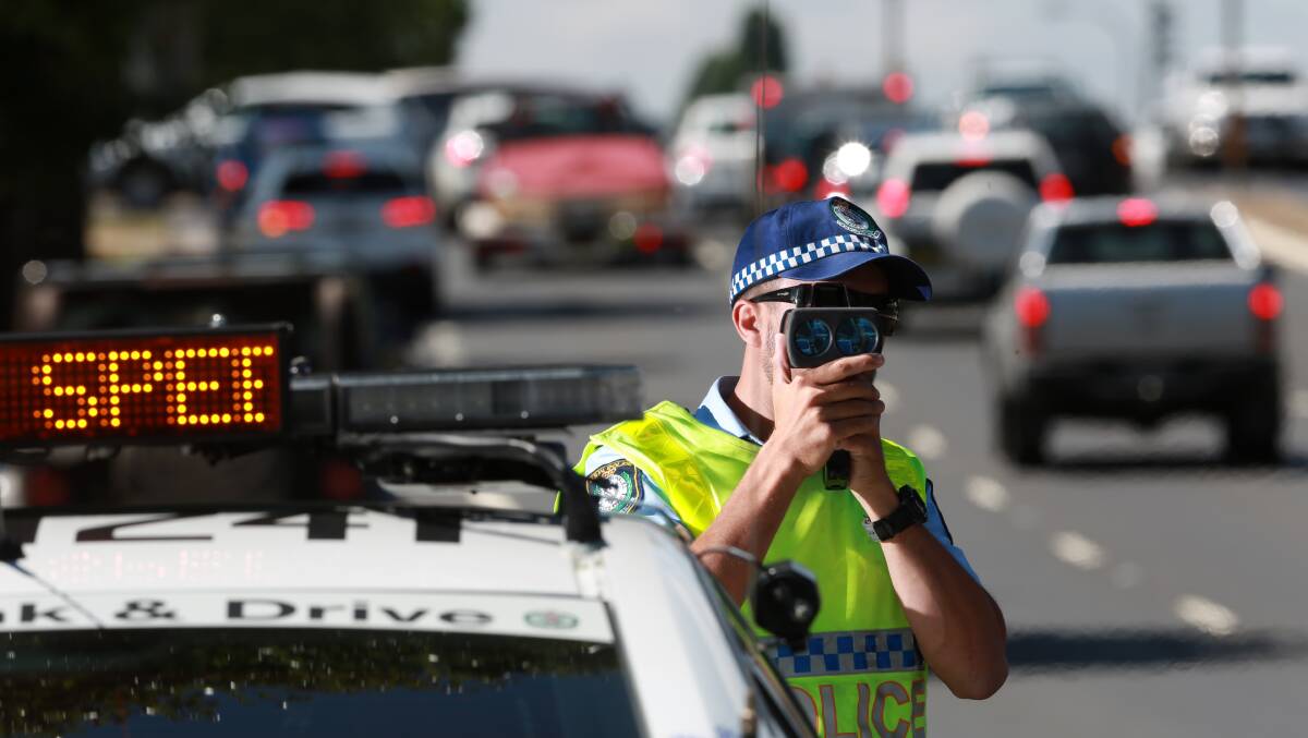 Police officer with speed camera. Picture by Phil Blatch.