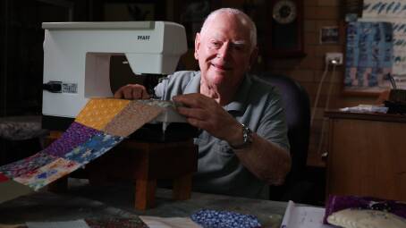 Barry Whitehead sits in front of his sewing machine making a quilt at his Barrack Heights home. Picture by Sylvia Liber