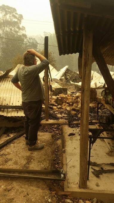 Peter Williams surveys the ruins of his beloved pottery and historic workplace after the Mogo fire. Peter Williams surveys the ruins of his beloved pottery and historic workplace after the Mogo fire.