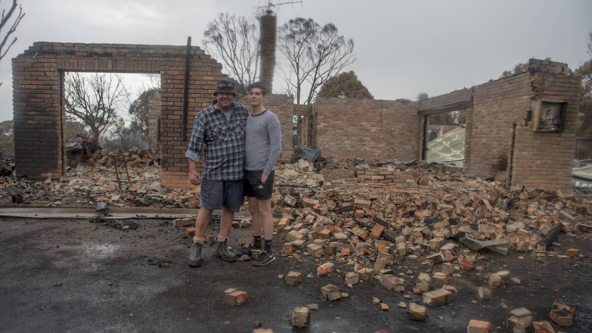 Kevin and Luke Lindley happy to be alive the day after their home was destroyed. Photo Jay Cronan

