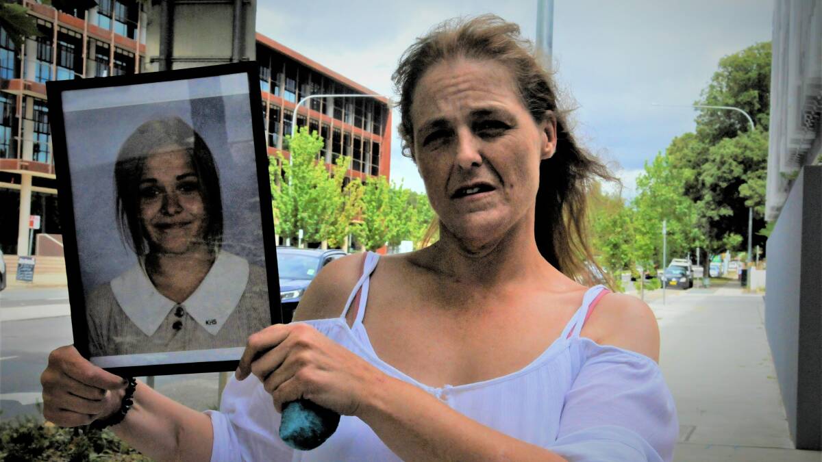 Charli Powell's mother, Sharon Moore, displays a picture of her outside the Queanbeyan courthouse in March. Picture: Blake Foden