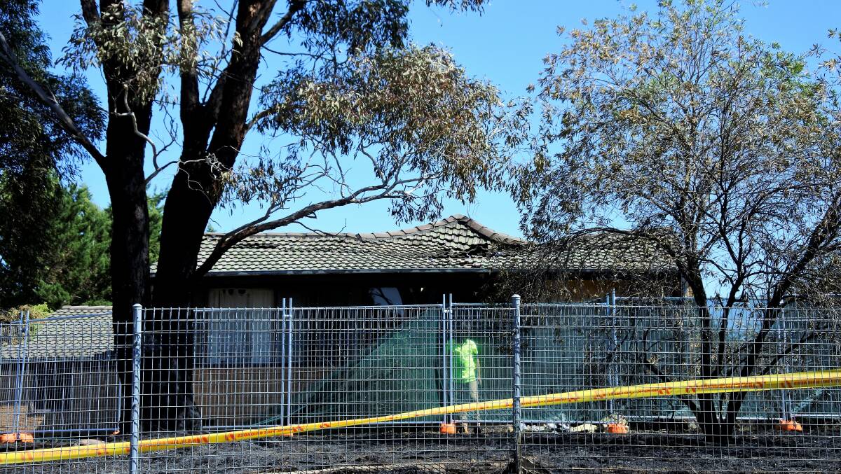 The Ullamulla Crescent home with damage to the roof visible after Monday's fire. Photo: Elliot Williams