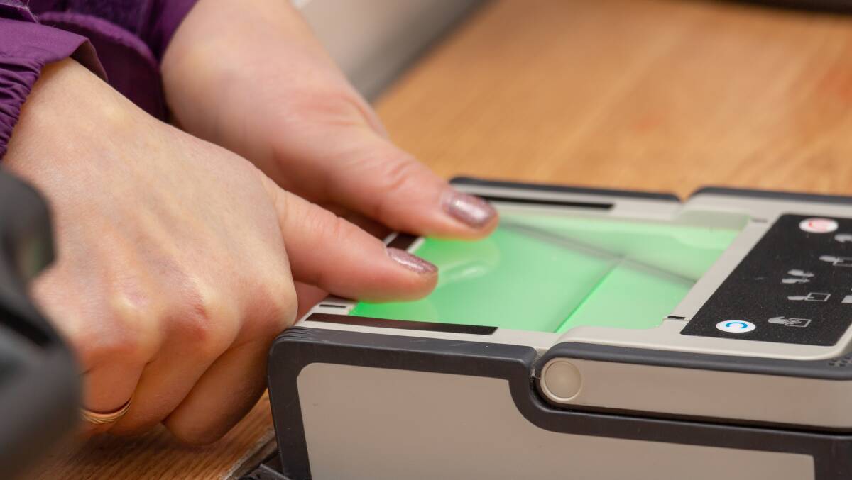 A passenger presents their fingerprints for scanning at border control. Picture by Shutterstock A passenger presents their fingerprints for scanning at border control. Picture by Shutterstock