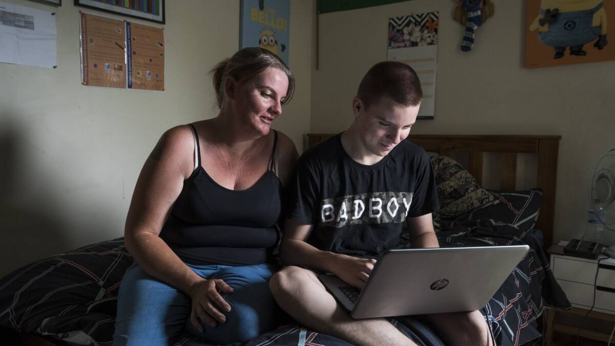 New computer: Roseanna Harris with her son Curtis Edward Harris, 14, who will receive a laptop from the ACT government this year. Photo: Dion Georgopoulos