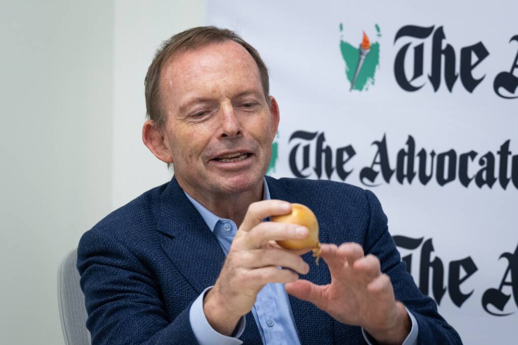 Tony Abbott checks out an onion. Picture David Bellamy