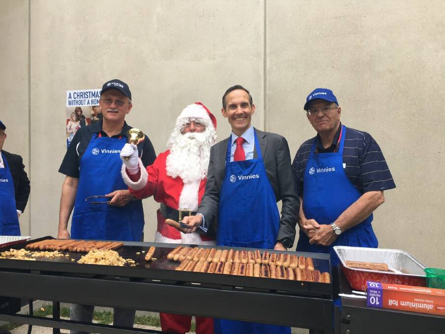 HELPING OUT: Santa and Andrew Leigh flanked by Vinnies volunteers.