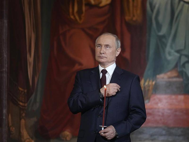 Russian leader Vladimir Putin crosses himself during the Orthodox Easter service in Moscow.