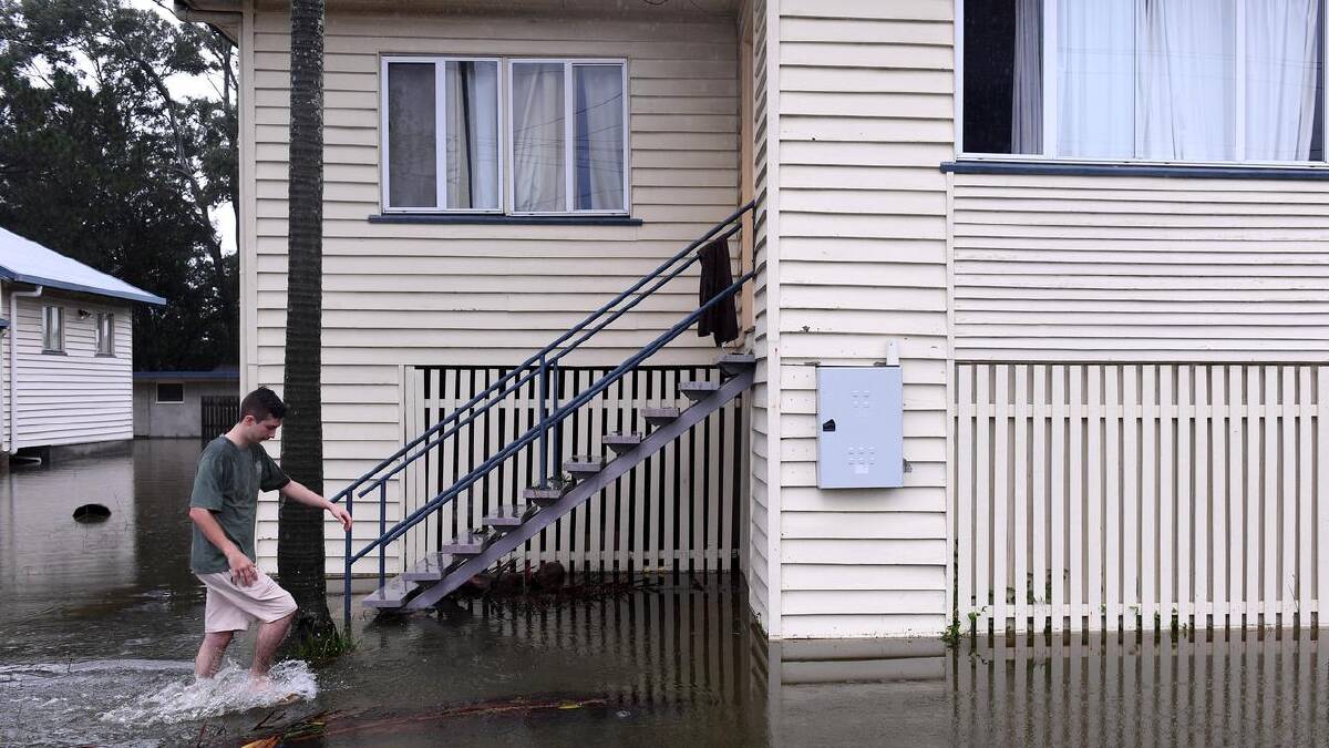 Renter Hayden Edwards is waiting for the water to subside to assess damage at his home.  (Jono Searle/AAP PHOTOS)